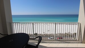 A balcony with a view of a beach and the ocean. - Majestic Sun 707A-1/1.5 bath condo with gulf views (Miramar Bch)