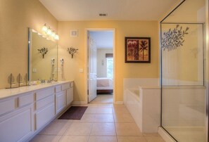 Classy bathroom of the condo in Orlando - Immerse yourself in the beauty of artistic expression in this vanity area - Fresh up yourself in a cozy bathtub or a glass enclosed shower area - Experience the refreshing ambiance