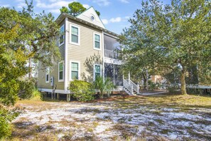 A two-story house with a front porch and a small staircase leading to a balcony. - Tropical Therapy is good for what ails you! (Pensacola)