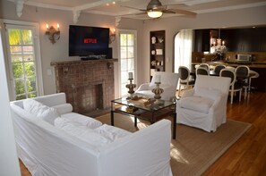 living room with dining room and kitchen in background