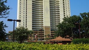 A high-rise hotel with multiple balconies and a central vertical feature. - 4 Bedroom Platinum Designer End Unit Incredible Gulf Views! Free Beach Chairs (Panama City Beach)