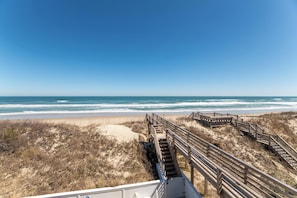 A beach with wooden boardwalks leading to the shore.