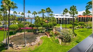 A hotel with a well-maintained garden, palm trees, and a fountain. - Roomy Maui Suite w/Loft, Relaxing Lanai, Kitchen Ease, WiFi–Kamaole Sands 10408 (KIHEI)