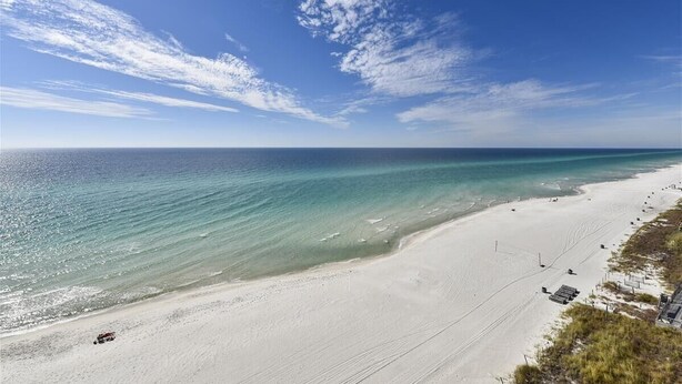 A beach with clear turquoise water, white sand, and a clear sky. - Tidewater 1 bedroom with gulf view, Summer dates open! (Panama City Beach)