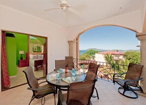 Relax on the balcony with a view of the surrounding landscape, surrounded by a round table and four chairs.