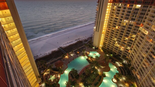 A high-rise hotel with a pool area and a view of the beach. - Incredible Views from the 22nd Floor! Free Activities + Summer Deals! (Panama City Beach)
