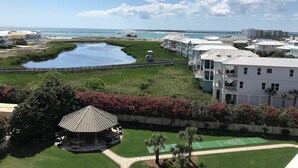 A coastal resort with a large water body, a tennis court, and a gazebo. - Sunset Views & Summer Beach Vibes – Islander 713 (Destin)