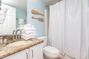 A bathroom with a sink, toilet, and shower curtain. - Royal Palms 1BR 2BA! Condo 1207 ~ (Gulf Shores)