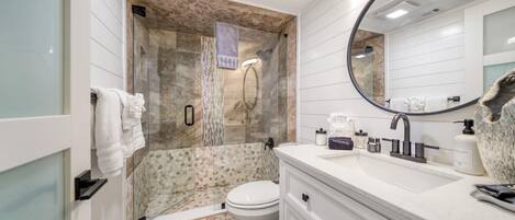 Bathtub, hair dryer, towels, shampoo