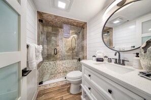 Bathtub, hair dryer, towels, shampoo