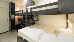 A bunk bed room with a desk and a ladder.