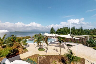 Beachfront retreat with pool, private hot tub, AC, & lagoon view