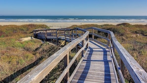 A wooden boardwalk leading to a beach with a clear view of the ocean. - Great views, swimming pool, boardwalk to the beach, picnic tables, play area, co (Port Aransas)