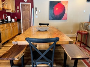 A dining area with a wooden table, black chairs, and a woven basket. - Ski In, Ski Out! Cozy Mountainside Townhome at Purgatory Resort - Edelweiss #7 (Durango)