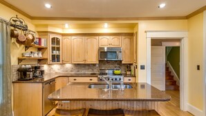 A kitchen with wooden cabinets, a granite countertop, and a stainless steel sink. - Beautiful Irvington Apartment near City Center! (Portland)