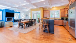 A spacious kitchen with wooden cabinets, a large island, and a built-in oven.