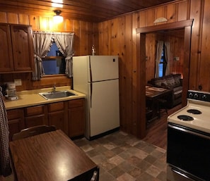 Enjoy cooking in this well-equipped kitchen with a dining table, stove, and refrigerator.