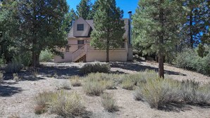 A house with a sloped roof, a visible staircase, and a chimney. - Lake Views! Lakefront! BBQ! Internet! Close to the Village! (Big Bear Lake)