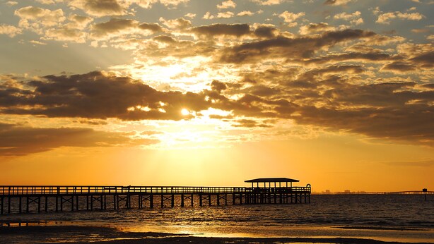 A pier extending into the water with a covered area at the end. - Key West Style Waterfront, Private Pool, WiFi, Close to Village & Beaches Pet OK (Safety Harbor)