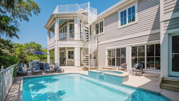 A two-story house with a swimming pool, outdoor furniture, and a covered patio area. - 43 Dune Lane - 2nd Row Dune Lane Luxury, 100ft from the Sand (Hilton Head Island)