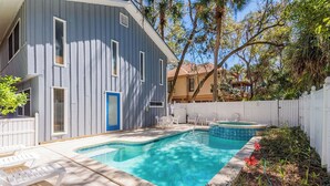 A backyard with a swimming pool, lounge chairs, and a hot tub. - 2 Bayberry - 4th Row Home, Short Walk to Beach! (Hilton Head Island)