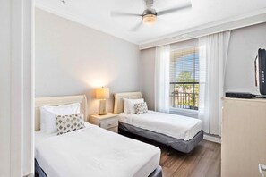 Relax and unwind in our inviting bedroom with two beds. Perfect for families or friends traveling together, this cozy space offers double the comfort for a restful night's sleep. - Magical 3BR Condo near Epic Universe! (Orlando)