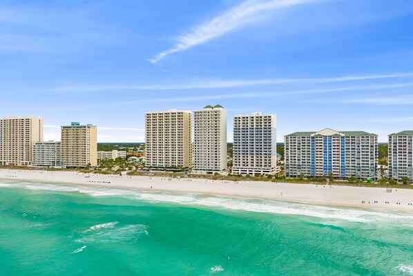 A beachfront hotel with multiple high-rise buildings, a sandy beach, and clear turquoise waters. - CONDO WITH AMAZING VIEWS & SPACIOUS BALCONY!! SLEEPS UP TO 8! (Panama City Beach)