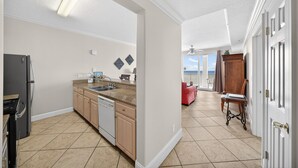 A kitchen with a dishwasher, a stove, and a sink. - CONDO WITH AMAZING VIEWS & SPACIOUS BALCONY!! SLEEPS UP TO 8! (Panama City Beach)