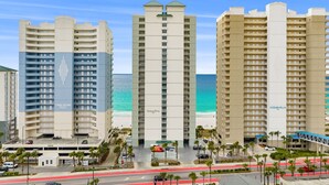 Three high-rise hotels with balconies, a parking area, and a beach view. - CONDO WITH AMAZING VIEWS & SPACIOUS BALCONY!! SLEEPS UP TO 8! (Panama City Beach)