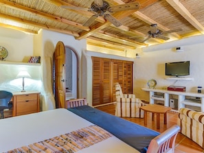 Relax in a spacious room with a large bed, desk, and comfortable seating area.