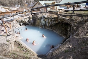 A natural hot spring with wooden walkways and a rustic stone structure. - ★ Epic Ski-In/Ski-Out Rocky Mountain Cabin w/ Private Hot Tub! Sleeps 11 (Granby)