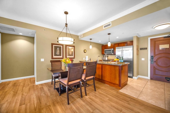 Dine indoors with views of the resort gardens through wide lanai doors that invite the breeze in.