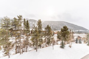 A snowy landscape with trees and a distant mountain range. - Ideally Located Keystone Condo w/ Mountain Views, Shared Pool & Hot Tub! (Keystone)