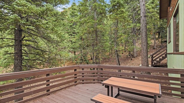 A wooden deck with benches, surrounded by trees. - Movie Theater! Pool Table! HOT TUB! Mtn Views! Multiple Decks! (Big Bear Lake)