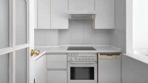 A modern kitchen with white cabinetry, a built-in oven, and a dishwasher. - Holiday Apartment with seaview (Marbella)