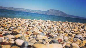 A pebble beach with a view of the sea and distant mountains. - Independent condo, with stunning view just a heartbeat away from the beach (Kokkonion)