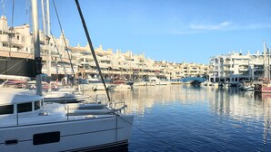 Uma marina com barcos atracados, rodeada por edifícios com arquitetura tradicional.