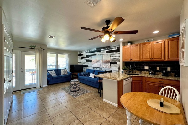 Your open-concept living space flows from kitchen to living room, perfect for relaxing on comfortable sofas after preparing meals.