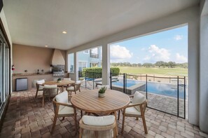 Outdoor dining - The Grande View | Infinity Pool & Summer Kitchen with Amazing Golf & Sunset Views (Kissimmee)
