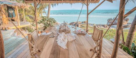 Enjoy a meal on the deck overlooking the sea.