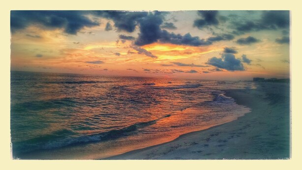 A beach with a sunset over the ocean. - A Special Getaway! (Panama City Beach)