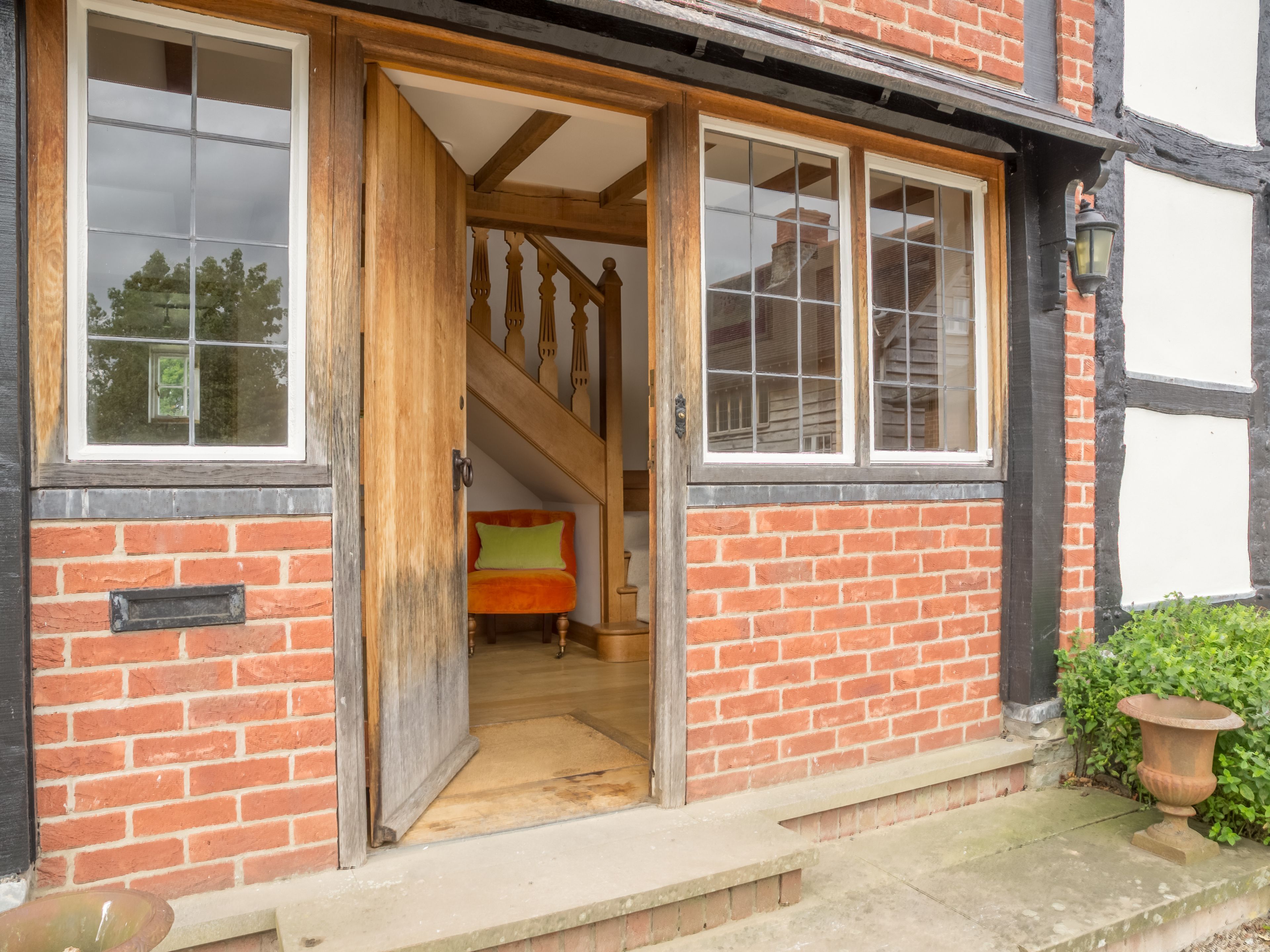 A traditional brick building with a wooden staircase leading to an upper floor.