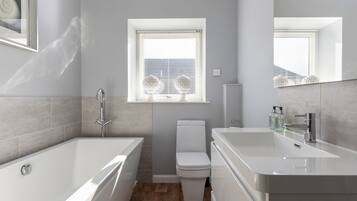 Bathtub, hair dryer, towels, soap