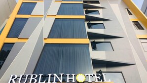 A modern hotel building with a geometric facade, multiple windows, and the name 'RUBLINHOTEL' prominently displayed. - Rublin Hotel (Cebu City)