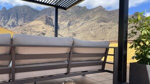 A seating area with a view of mountains.