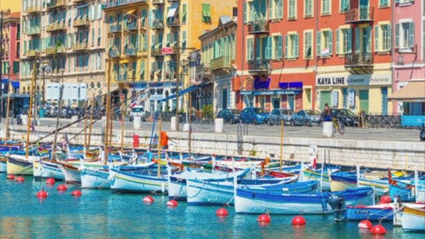 A waterfront property with colorful buildings, a marina with boats, and a sign for 'KAYA LINE'. - SunlightProperties AMOUR VIOLETTE: Hyper Center, 2 bedroom apt with terrace (Nice)