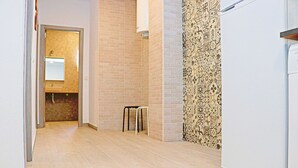 A hallway with a tiled floor, a sink, and a refrigerator. - Rural apartment for four people (CONIL DE LA FRONTERA)
