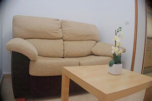 Relax in this serene living space with a comfortable sofa and a stylish coffee table.