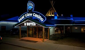 A building with a neon sign reading "Bear Claw Casino & Hotel". - Bear Claw Casino & Hotel (Carlyle)