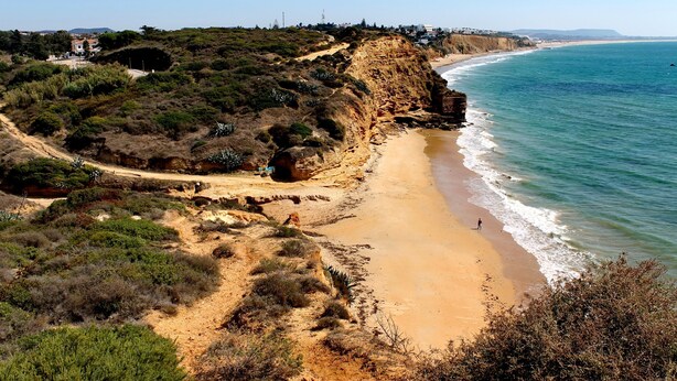 A coastal landscape with a sandy beach, rocky cliffs, and sparse vegetation. - Villa with private pool in rural area (CONIL DE LA FRONTERA)